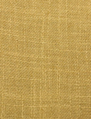Close-up of the golden linen fabric on the Clementine platform bed