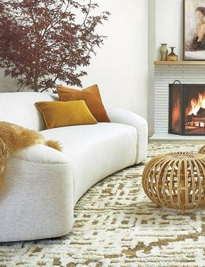 Charlotte mustard lumbar velvet pillow sits on a linen sofa with the burnt orange velvet throw pillow