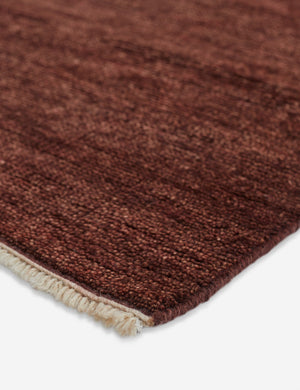 Fringed corner of the heritage brick red rug