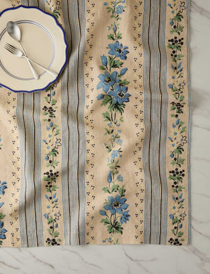 Overhead view of a place setting with the Golden floral stripe linen tablecloth by Heidi Caillier underneath