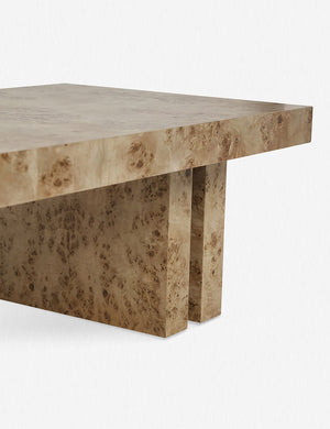 Angled right corner of the Brisa rectangular burl wood coffee table with four legs