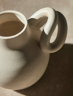 Downward angled view of the Canal white rounded vase by Salamat Ceramics with sculptural arm