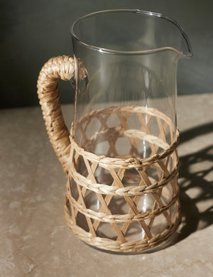 Close-up of the Shelly glass pitcher with natural seagrass accent