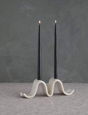 Wyn white Candelabra by SIN with an undulating silhouette and two black taper candles