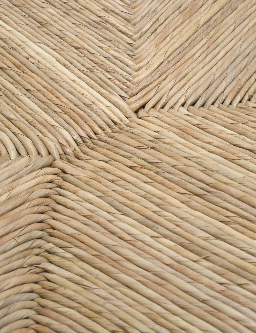 | Detailed shot of the woven rattan material on the Nolani arm chair